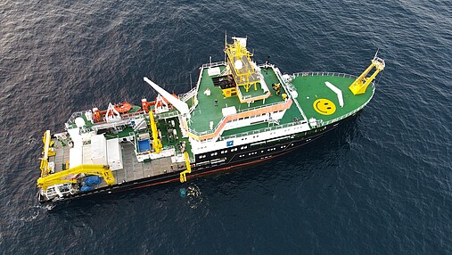 Foto zum Thema "Ausbildung zum Schiffsmechaniker": Zu sehen ist die Atair aus der Luft. Auf dem Deck ist ein lachender Smiley erkennbar.